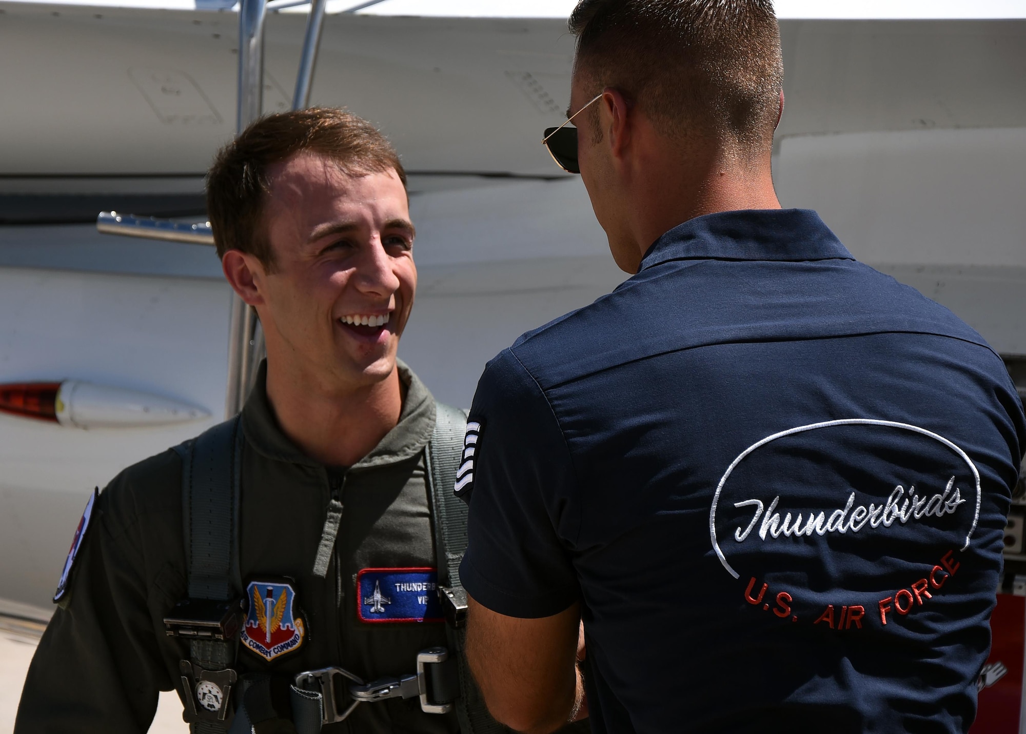 Sage Kimzey, championship bull rider, speaks with Tech. Sgt. Christopher Audet, U.S. Air Force Thunderbirds line chief, July 25, 2016, on the Wyoming Air National Guard Base, Cheyenne, Wyo. Kimzey is a championship bull rider who is competing in the CBR World Finals during Cheyenne Frontier Days. (U.S. Air Force photo by Senior Airman Brandon Valle)