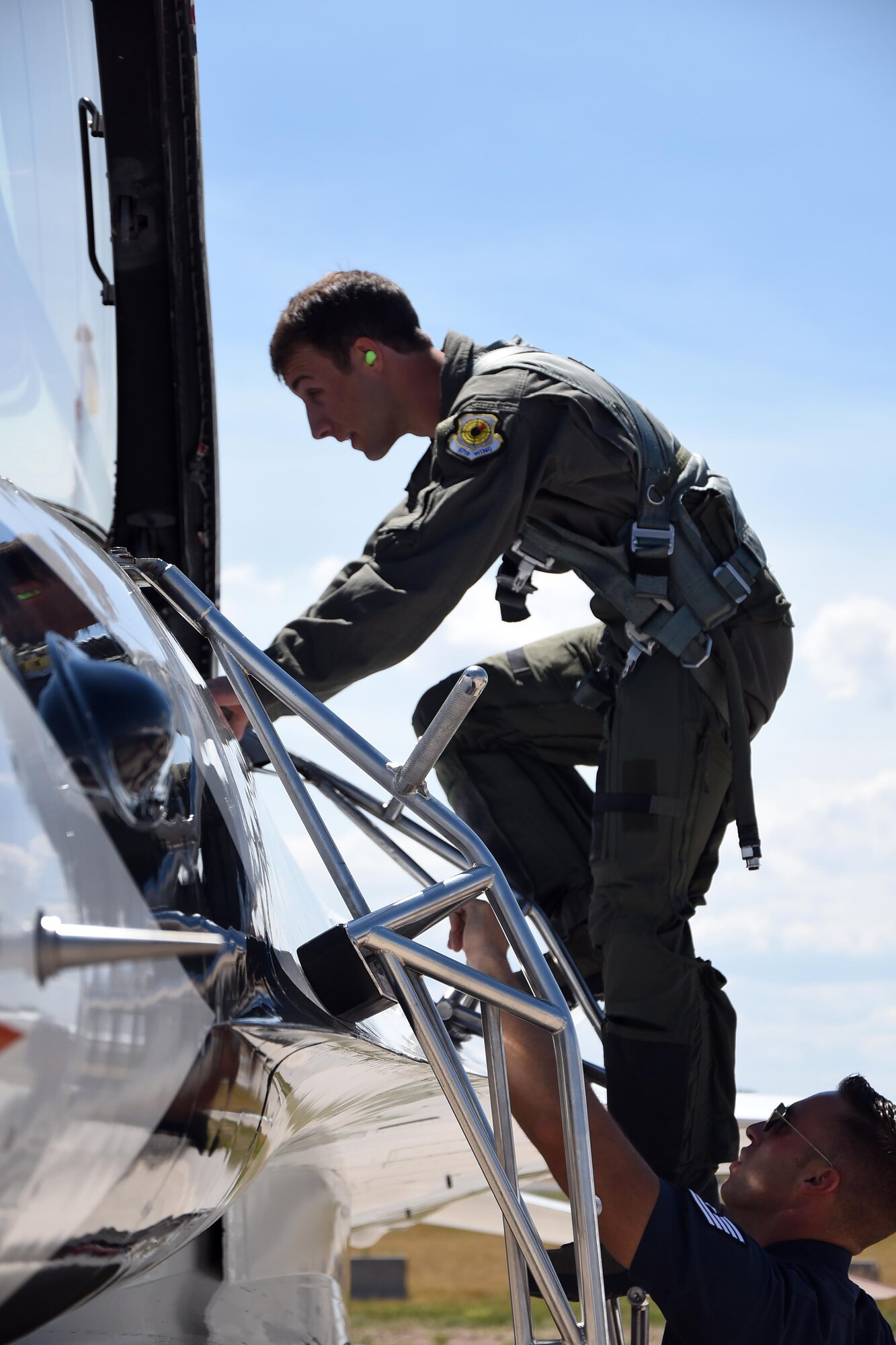 Sage Kimzey, championship bull rider, climbs into a U.S. Air Force Thunderbirds F-16 July 25, 2016 before participating in a celebrity flight around Cheyenne, Wyo. Kimzey rode in the passenger seat as a Thunderbirds pilot performed aerial maneuvers. (U.S. Air Force photo by Senior Airman Brandon Valle)