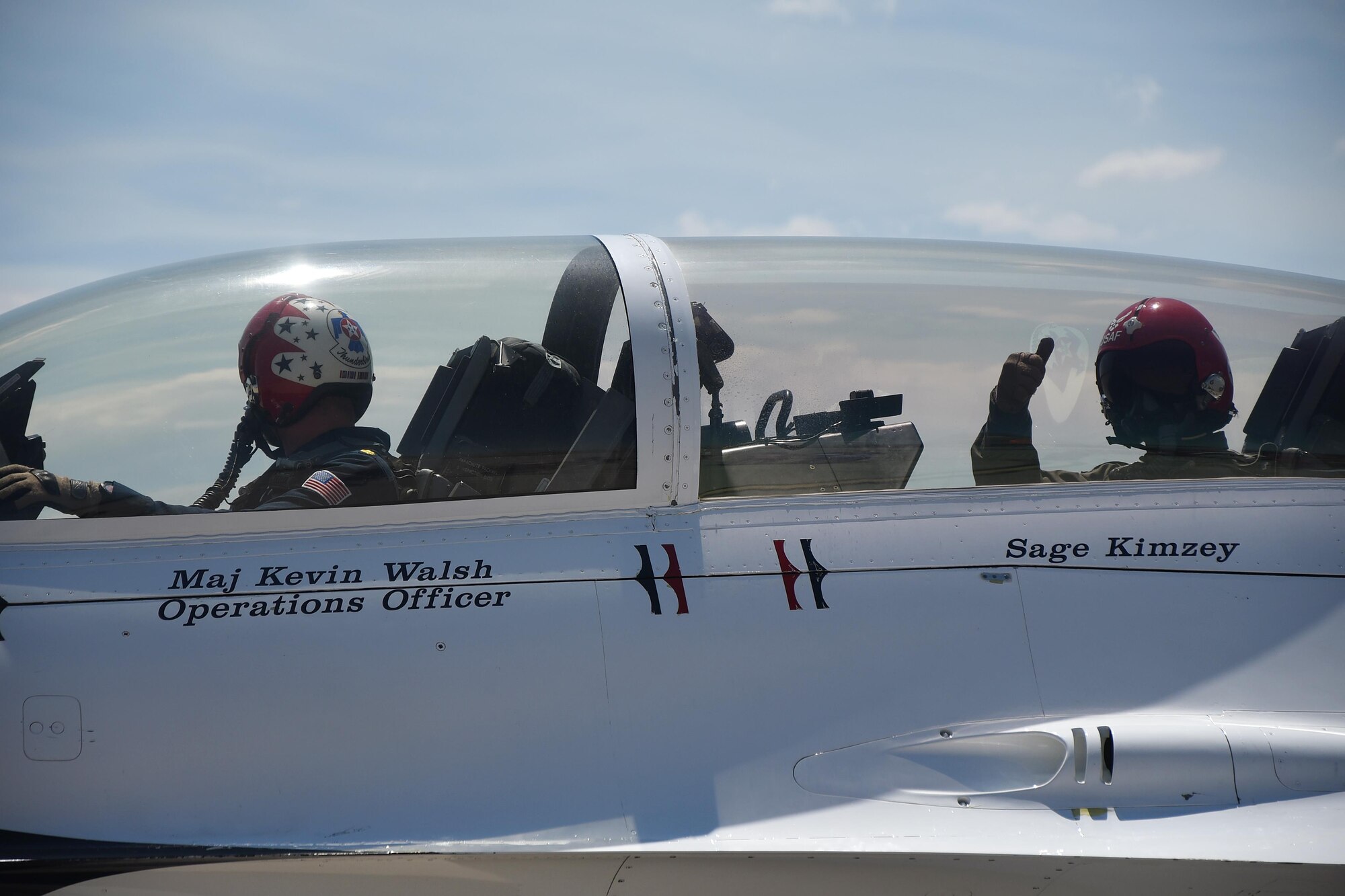 Maj. Kevin Walsh, U.S. Air Force Thunderbirds operations officer, and Sage Kimzey, championship bull rider, begin their final preparations for takeoff July 25, during a celebrity flight over the skies of Cheyenne, Wyo. Kimzey is a championship bull rider who is competing in the CBR World Finals during Cheyenne Frontier Days. (U.S. Air Force photo by Senior Airman Brandon Valle)