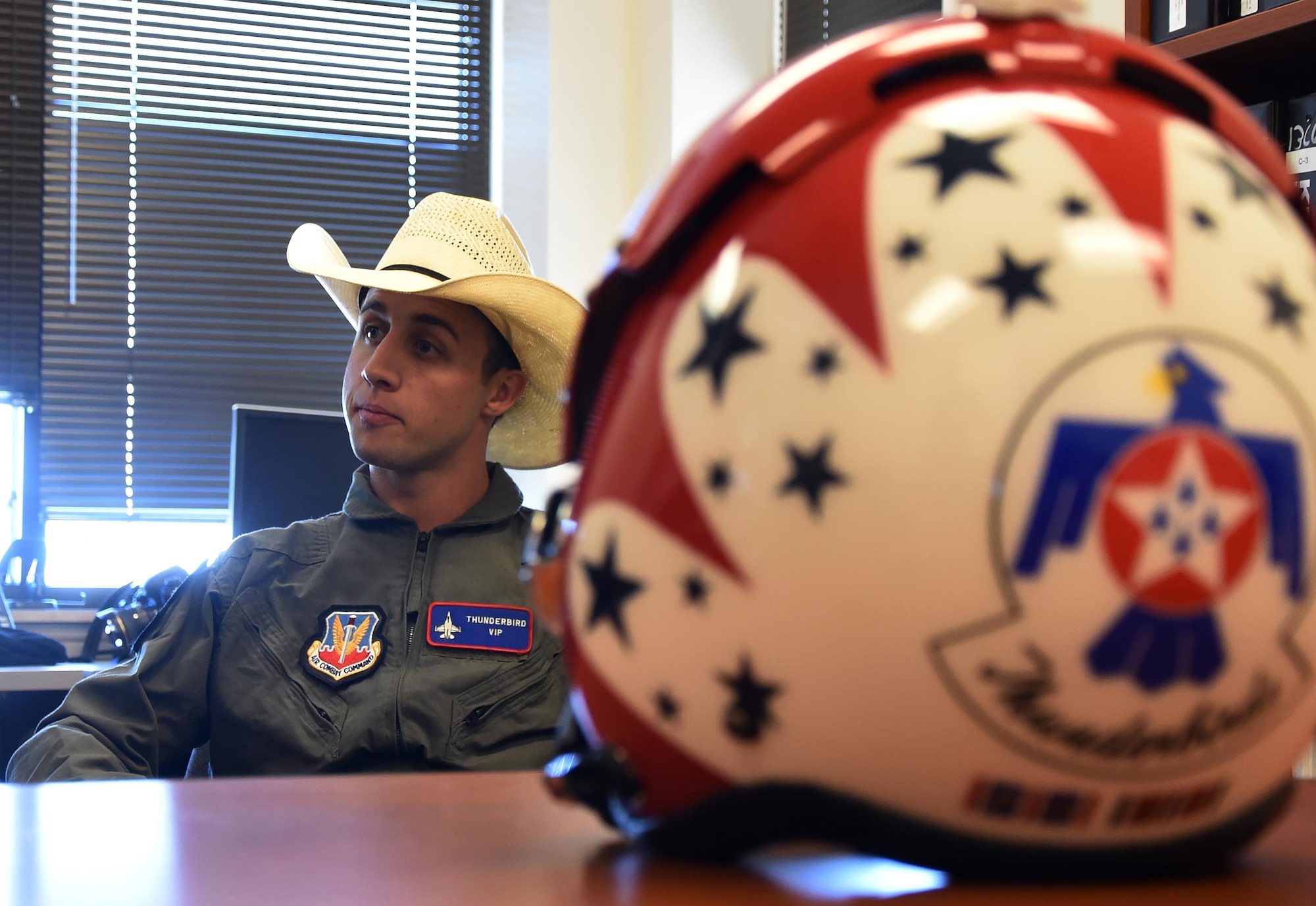 Sage Kimzey, championship bull rider, listens to a safety briefing before embarking on a Thunderbirds flight July 25, 2016, on the Wyoming Air National Guard Base, Cheyenne, Wyo. Safety is always the primary concern when preparing for flight. (U.S. Air Force photo by Senior Airman Brandon Valle)