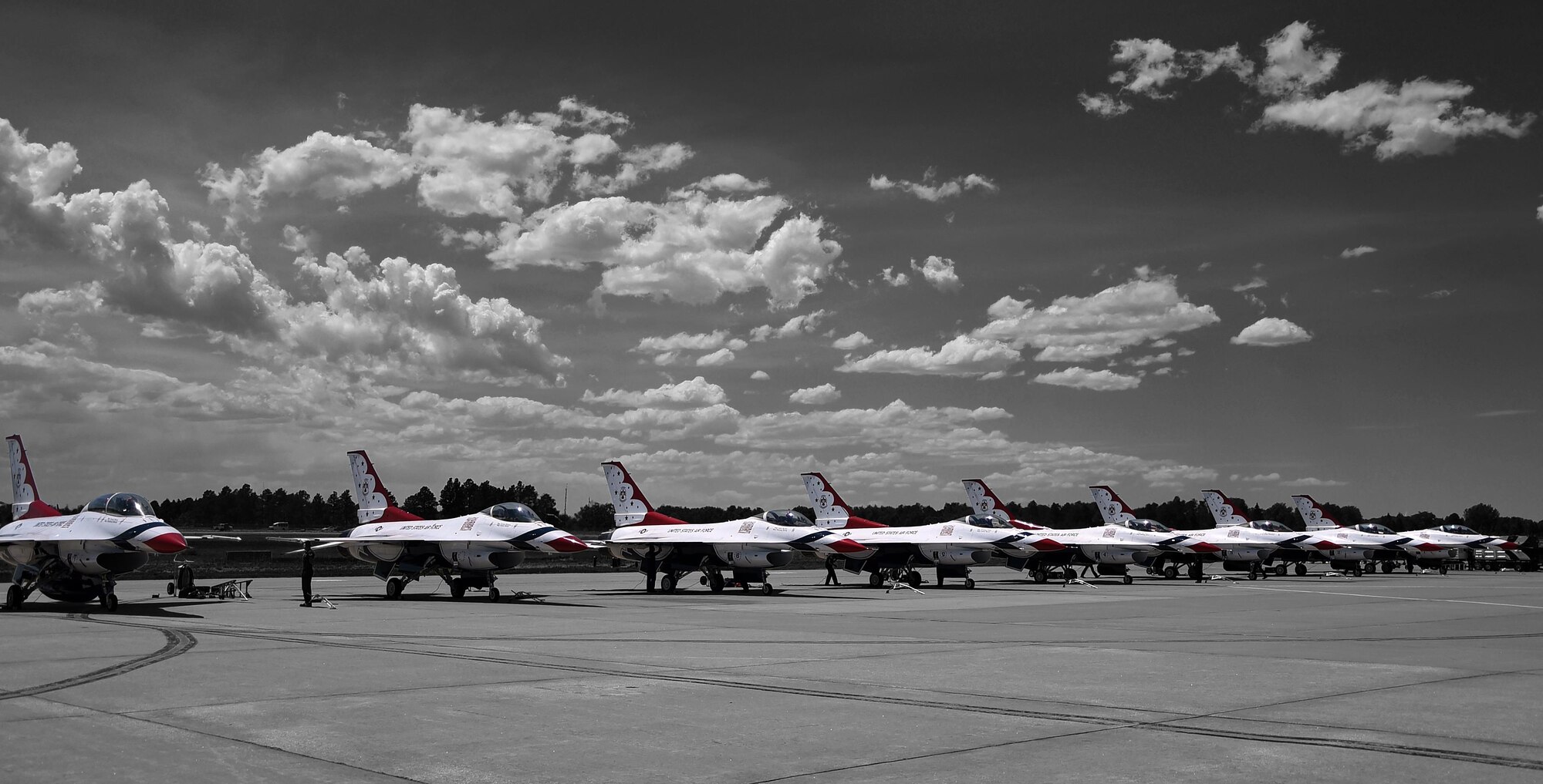 U.S. Air Force F-16 Fighting Falcon aircraft stage on the flight line on the Wyoming Air National Guard Base, Cheyenne, Wyo., July 25, 2016. Maj. Kevin Walsh, U.S. Air Force Thunderbirds operations officer, took Sage Kimzey, championship bull rider, on a one-hour celebrity flight throughout the surrounding area.  (U.S. Air Force photo illustration by Senior Airman Brandon Valle)