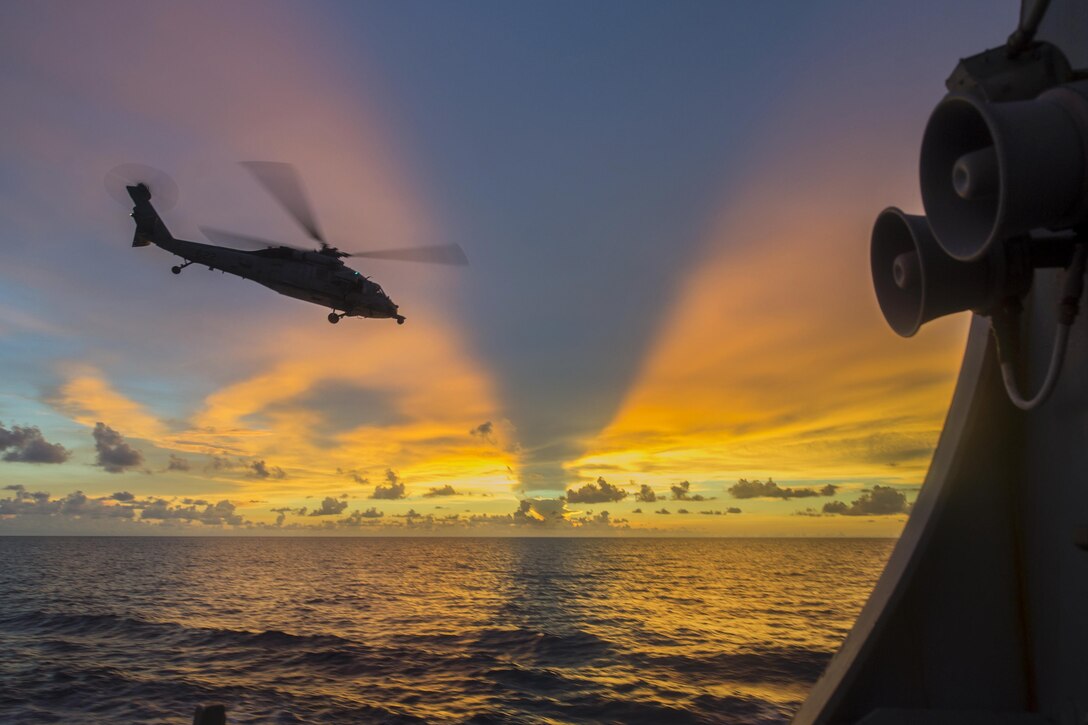 An MH-60S Seahawk helicopter departs from the flight deck of the guided-missile destroyer USS McCampbell during visit, board, search and seizure training in the South China Sea, July 22, 2016. The McCampbell is patrolling with Carrier Strike Group Five in the U.S. 7th Fleet area of responsibility supporting security and stability in the Indo-Asia-Pacific region. The helicopter is assigned to Helicopter Sea Combat Squadron 12. Navy photo by Petty Officer 3rd Class Elesia K. Patten