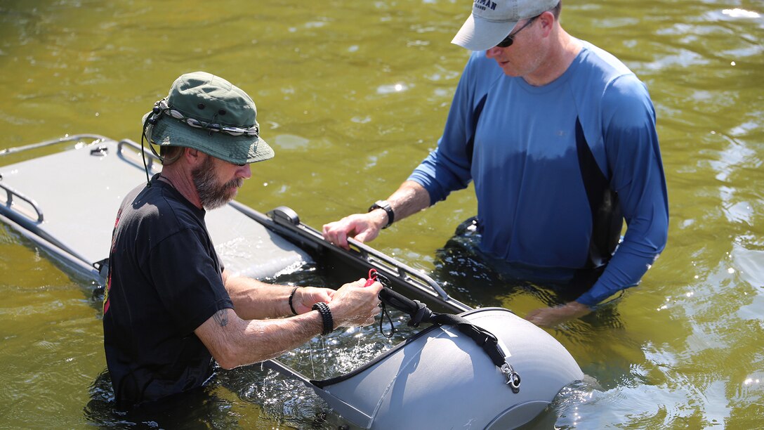 Ed Maziarski (left) and Jake Feeney of Reconnaissance and Amphibious Raids at Marine Corps Systems Command prepare a diver propulsion device for testing July 18 at Lake Anna in Spotsylvania, Virginia. The team worked with Marine combatant divers to conduct tests of potential upgrades to the DPD to improve its speed and controllability.