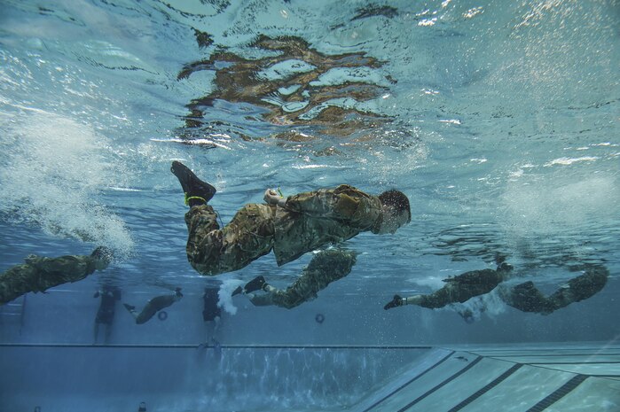 Special Tactics Training Squadron students swim the length of the pool with their hands and feet bound during a pre-scuba class at Hurlburt Field, Fla., June 29, 2016. The training familiarizes trainees with the basics of water operations. The trainees perform tasks such as tying knots underwater, learning how to stay afloat without their arms and hands, and how to use snorkeling gear. Special Tactics students later apply this knowledge to combat dive training. This training also reproduces physiological effects similar those experienced on the battlefield, and thus builds the necessary mental resiliency for ground special operations force. (U.S. Air Force photo by Senior Airman Ryan Conroy) 
