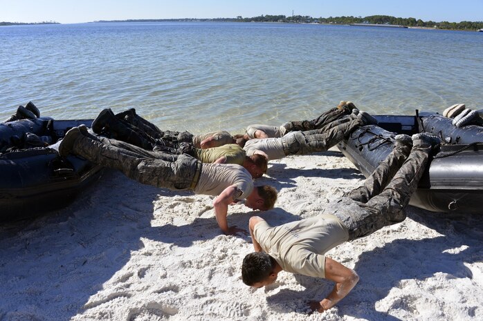 Special Tactics officer candidates perform pushups on a Zodiac boat during a selection at Hurlburt Field, Fla., Oct. 21, 2014. Special Tactics career field training pipelines are some of the most physically and psychologically challenging in the Air Force. To ensure the correct individuals are on the battlefield, a group of Special Tactics Airmen weed out the cross-training candidates who don’t meet the high standards, putting them through a week-long selection process to select only the best-qualified individuals. (U.S. Air Force photo by 1st Lt. Katrina Cheesman) 
