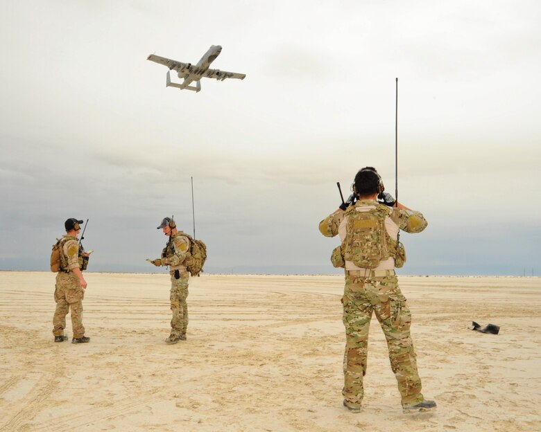 U.S. Air Force combat controllers from the 23rd Special Tactics Squadron, Hurlburt Field, Fla., perform air traffic control radio transmissions to an A-10C Thunderbolt II pilot of the 354th Fighter Squadron, Davis-Monthan Air Force Base, Ariz., approaching an austere landing strip during training at White Sands Missile Range, N.M., Dec. 4, 2014.  The combat controllers set up the landing strip as part of their initial and reoccurring training.  (U.S. Air Force photo by Airman 1st Class Chris Massey/Released)