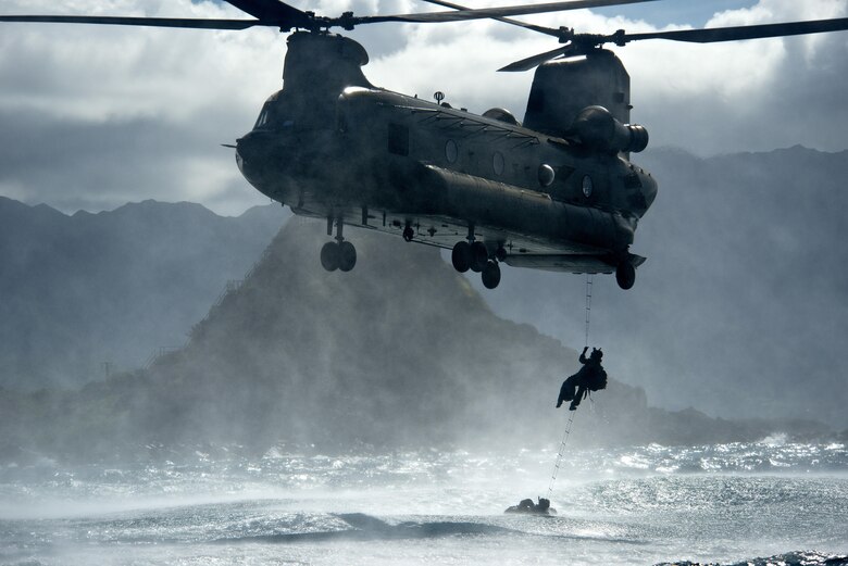 An Airman from the 22nd Special Tactics Squadron climbs into a U.S. Army CH-47 Chinook during helo-casting training operations off the coast of Hawaii. The five-foot ocean swells provided the operators with a challenging environment. (U.S. Air Force photo/Master Sgt. Jeffrey Allen)