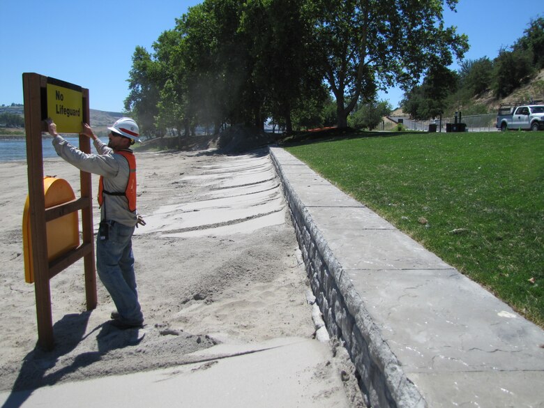 U.S. Army Corps of Engineers Maintenance Worker Jeremiah Harris puts the finishing touches on a new life-ring station at the Chestnut Recreation Area in Clarkston, Washington. The recreation area will reopen for visitors on Wednesday, July 27, following the replacement of a 240-feet-long dilapidated rock-and-mortar wall, which was falling apart and beginning to pose a safety risk to visitors. (U.S. Army Corps of Engineers photo.)