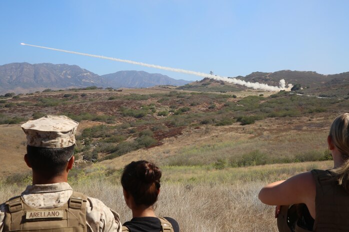 Marines and their families watch Marines with 5th Battalion, 11th Marine Regiment fire the M142 High Mobility Artillery Rocket System at a Jane Wayne Day event on Camp Pendleton, Calif., July 16, 2016. The event included the HIMARS live fire, a crew-served weapons demonstration, an M777A2 Howitzer shoot, a helicopter gun run with one UH-1Y Huey helicopter, two AH-1W Cobra helicopters and one AH-1Z Cobra helicopter, and an opportunity for family members to shoot the M4 carbine. (U.S. Marine Corps photo by Lance Cpl. Shellie Hall)