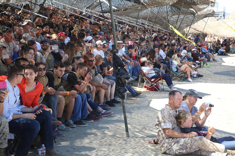 Nearly 700 Marines and their family members cluster in the shade during various live fire portions of a Jane Wayne Day event on Camp Pendleton, Calif., July 16, 2016. The event included the HIMARS live fire, a crew-served weapons demonstration, an M777A2 Howitzer shoot, a helicopter gun run with one UH-1Y Huey helicopter, two AH-1W Cobra helicopters and one AH-1Z Cobra helicopters, and an opportunity for family members to shoot the M4 carbine. (U.S. Marine Corps photo by Lance Cpl. Shellie Hall)