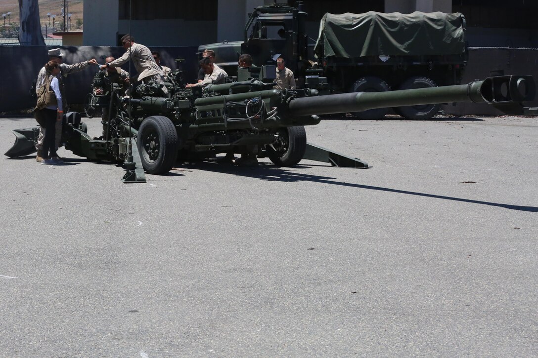 Marines answer questions about the M777A2 Howitzer during a Jane Wayne Day event on Camp Pendleton, Calif., July 16, 2016. The event included multiple live fire exercises, static displays of vehicles, weapons and helicopters, and a barbecue. (U.S. Marine Corps photo by Lance Cpl. Shellie Hall)