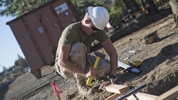 Lance Cpl. Dylan Hunt, a combat engineer with Engineer Services Company, Combat Logistics Battalion 23, Combat Logistics Regiment 4, 4th Marine Logistics Group, Marine Forces Reserve, helps prepare the foundation for an ATV storage shed during Exercise Forest Rattler in Bend, Oregon, July 20, 2016. This opportunity to train with the U.S. Forest Service provides realistic, cost-effective training, and allows the Marine Corps to give back to the community. 
