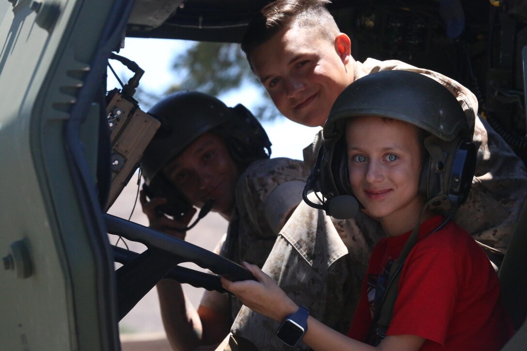 A boy sits in a logistics vehicle system during a Jane Wayne Day event on Camp Pendleton, Calif., July 16, 2016. The Jane Wayne Day event gives Marines and their families a chance to bond while becoming familiar with what the Marines experience through hands-on events and live fire exercises. (U.S. Marine Corps photo by Lance Cpl. Shellie Hall)