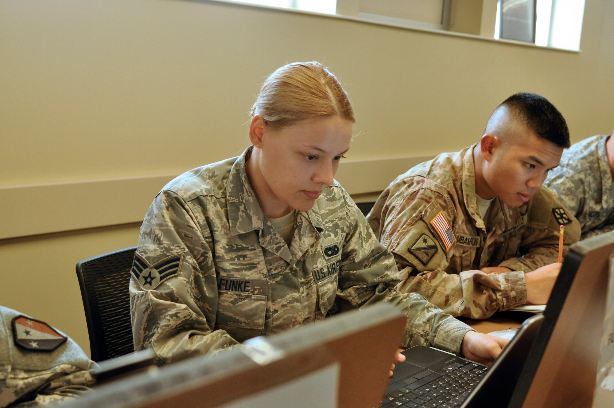 Senior Airman Erica Funke studies alongside her Army classmates July 20 during their 22-day course at the Army's non-commissioned officer academy. Funke was one of six Airmen to take the course. (U.S. Air Force photo/Senior Airman Jasmine Zielomski)