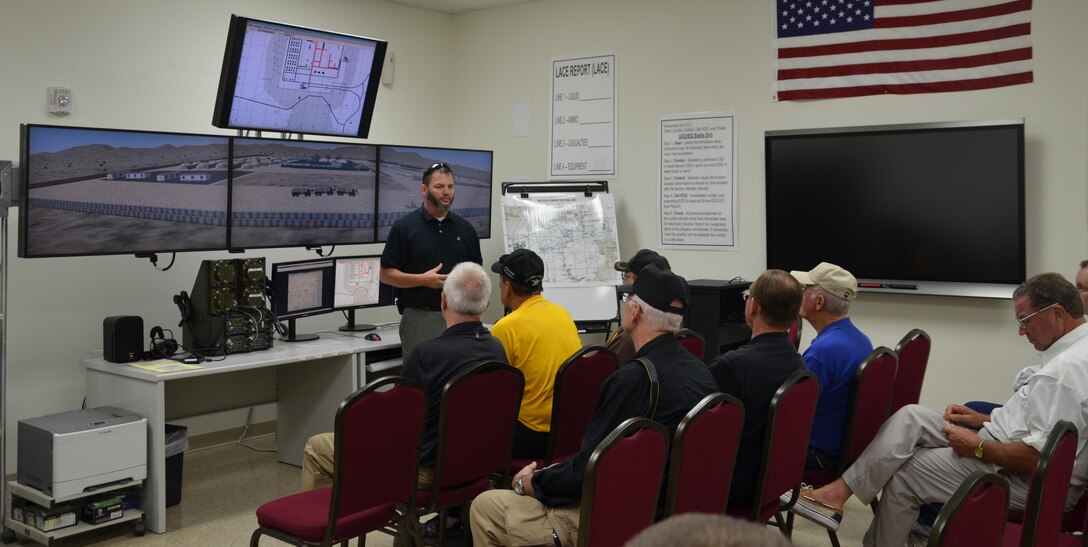 Army Reserve Ambassadors attending the 88th Regional Support Command’s Army Reserve Ambassador Workshop July 16, get a briefing before driving through a virtual environment and fighting off an attack in the Reconfigurable Vehicle Tactical Trainer on Fort McCoy.