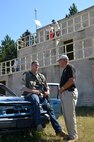 Doug Gibbens, Army Reserve Ambassador for the state of Indiana, speaks with a Soldier participating in a convoy ambush training exercise by the 86th Training Division.