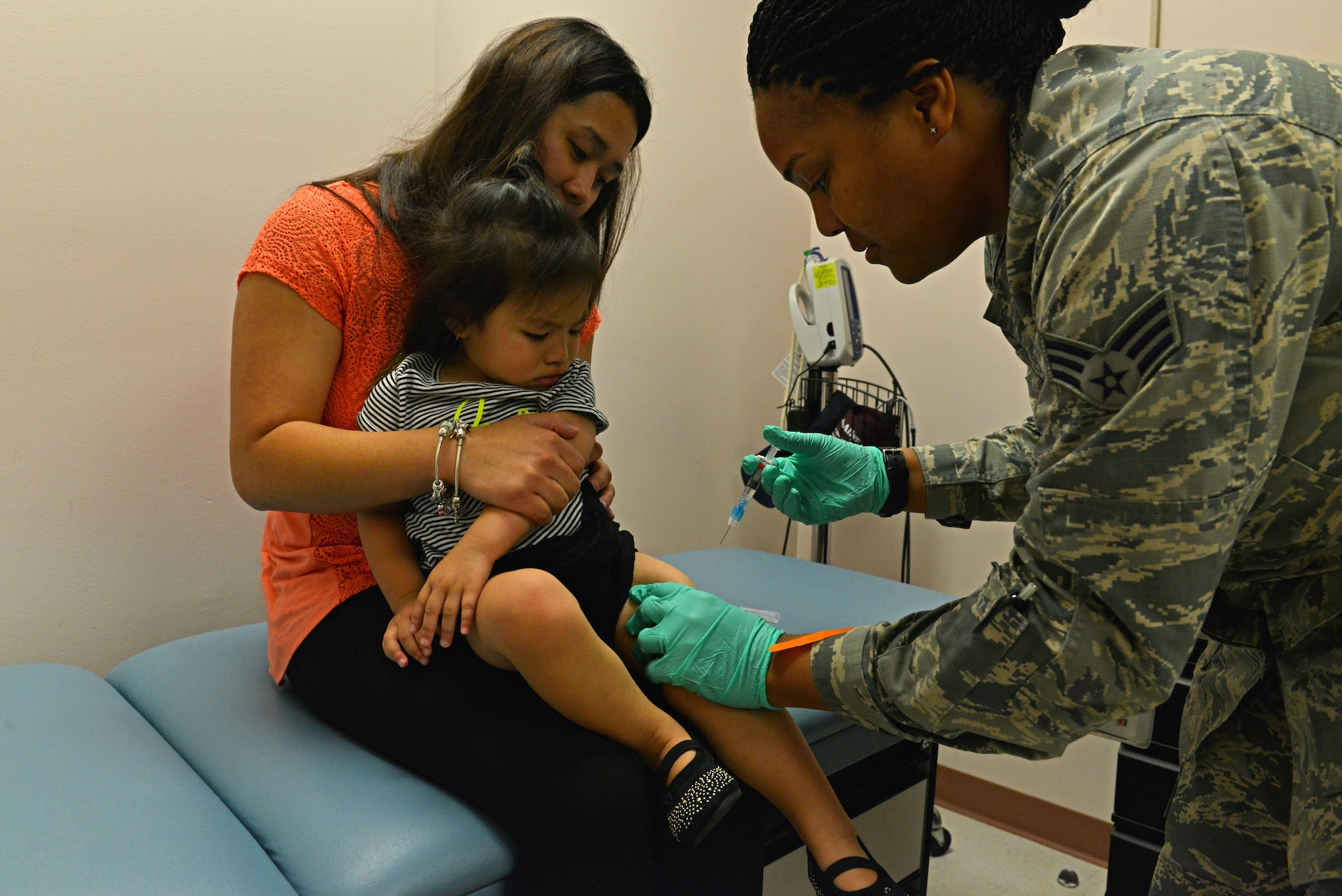 U.S. Air Force Senior Airman Tamika Bradley, 20th Medical Operations Squadron allergy and immunizations technician, prepares to administer a vaccine to a Team Shaw child at Shaw Air Force Base, S.C., July 20, 2016. Vaccines work by introducing a dead or weakened cell of a disease into the body, giving the immune system a chance to develop protection in the form of antibodies for the future. (U.S. Air Force photo by Airman 1st Class Destinee Dougherty)