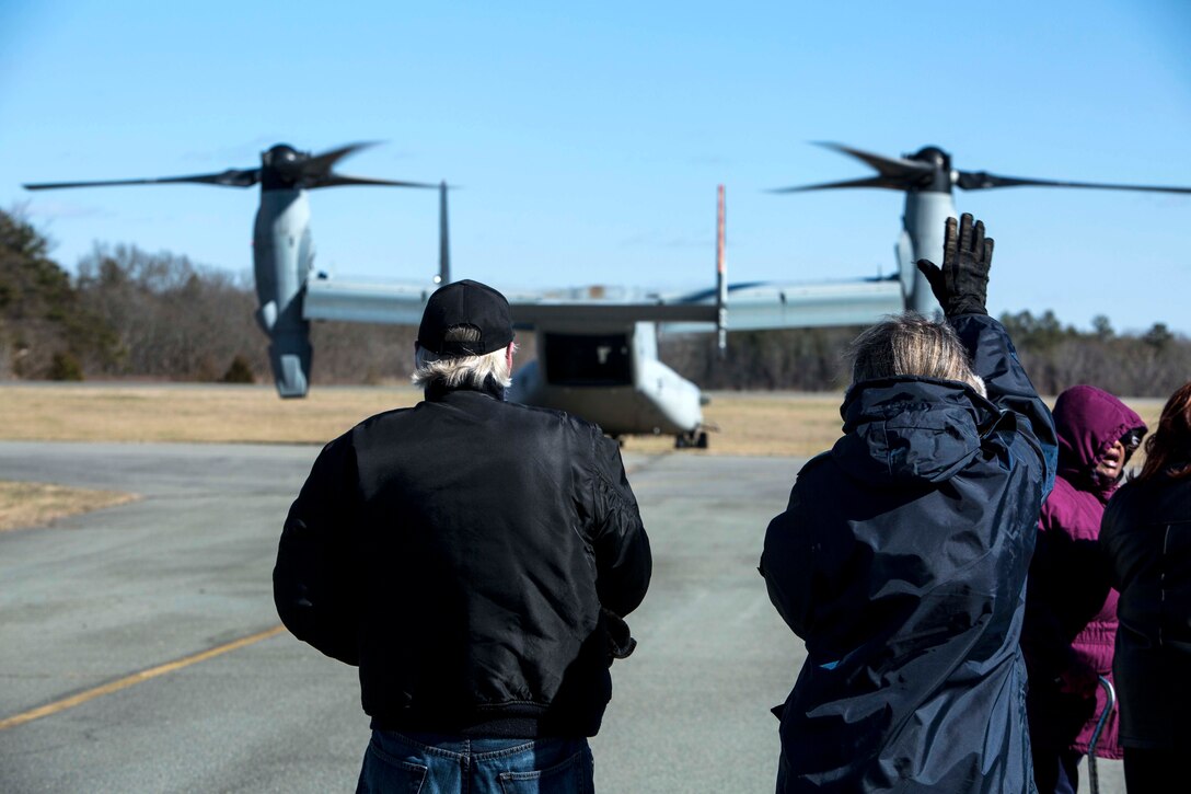 Local civilians wave goodbye to U.S. Marines as they depart a community relations event in a V-22 Osprey at South Boston, Va., Feb. 13, 2015. The Marines of 22nd Marine Expeditionary Unit hosted a community relations day where they showcased their aircraft, tactical vehicles and weapons systems. (U.S. Marine Corps photo by Lance Cpl. Koby I. Saunders/ 22nd Marine Expeditionary Unit / Released)