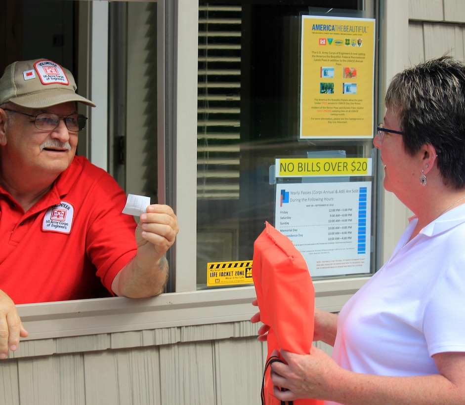 A visitor to Hurricane Bridge Recreation Area at Center Hill Lake in Smithville, Tenn., receives free entry after displaying her life jacket on "Life Jackets Saves and Pays Day" July 23, 2016.