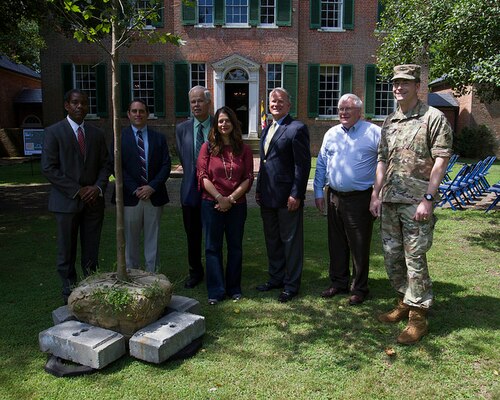 Project team members, property owner John Walton and  Col. Edward Chamberlayne, commander, U.S. Army Corps of Engineers, Baltimore District gather around the commemorative Sycamore tree during the commemoration of the Piscataway Creek Wetlands Mitigation Project at Poplar Hill Mansion in Clinton, Md., June 30, 2016. The Corps of Engineers has supported Joint Base Andrews in identifying an acceptable wetland mitigation site since 2010.