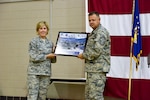 New York Air National Guard Command Chief Master Sgt. Amy Giaquinto and former N.Y. Air National Guard Command Chief Master Sgt. Richard King display an award following Change of Authority ceremonies at New York State Division of Military and Naval Affairs headquarters in Latham, N.Y. on Monday, July 25, 2016. 