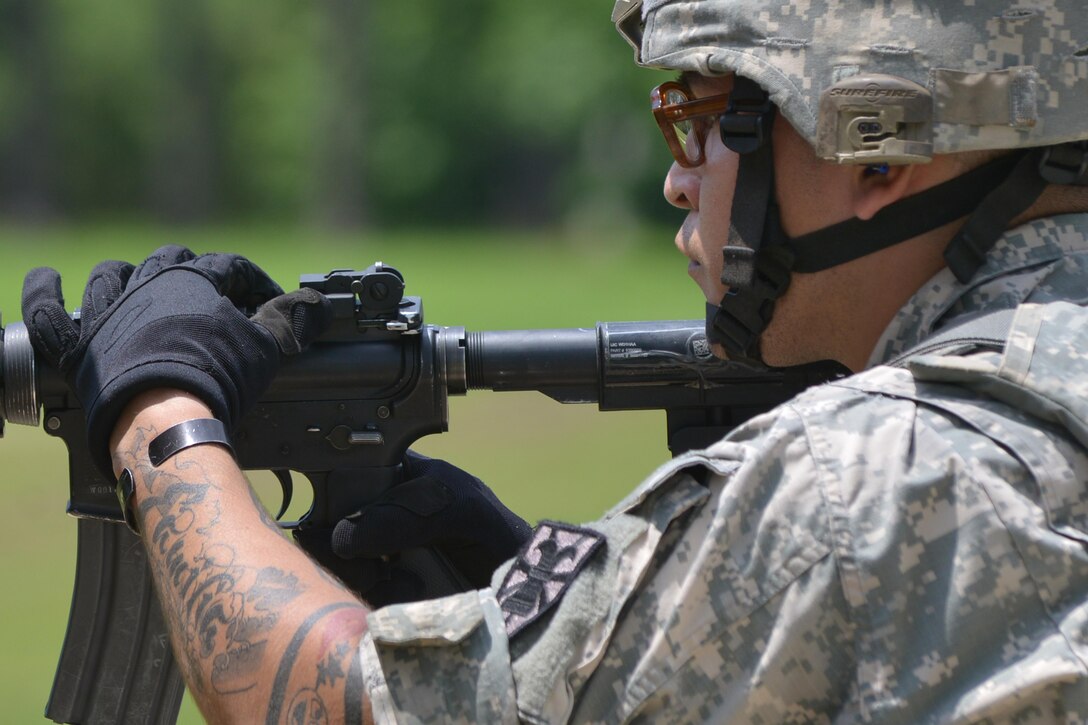 U.S. Army Sgt. Miguel Cruz, 7th Transportation Brigade (Expeditionary) Headquarters Company wheeled mechanic, lines his site during a range training exercise at Fort Eustis, Va., July 20, 2016. The training involved moving targets to test how Soldiers would react in a combat situation. (U.S. Air Force photo by Staff Sgt. Natasha Stannard)