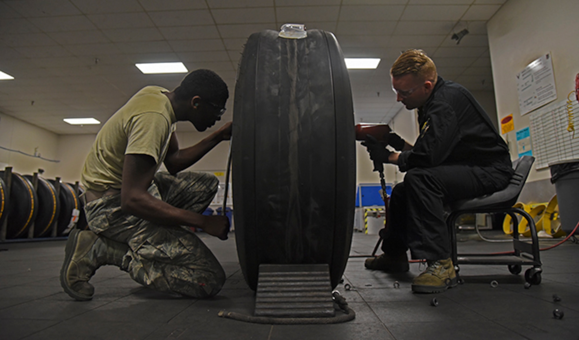 Airman 1st D’Andre Davis, 92nd Maintenance Squadron aerospace repair apprentice, assists in break down of a tire with Airman 1st Class Cody Mathews, 92nd MXS aerospace repair journeyman, at Fairchild Air Force Base July 22, 2016. The aerospace repair shop is tasked with wheel and tire assembly for all KC-135 Stratotanker operations within Pacific Air Force as well as KC-135 operations at Fairchild. (U.S. Air Force photo/Airman 1st Class Mackenzie Richardson) 