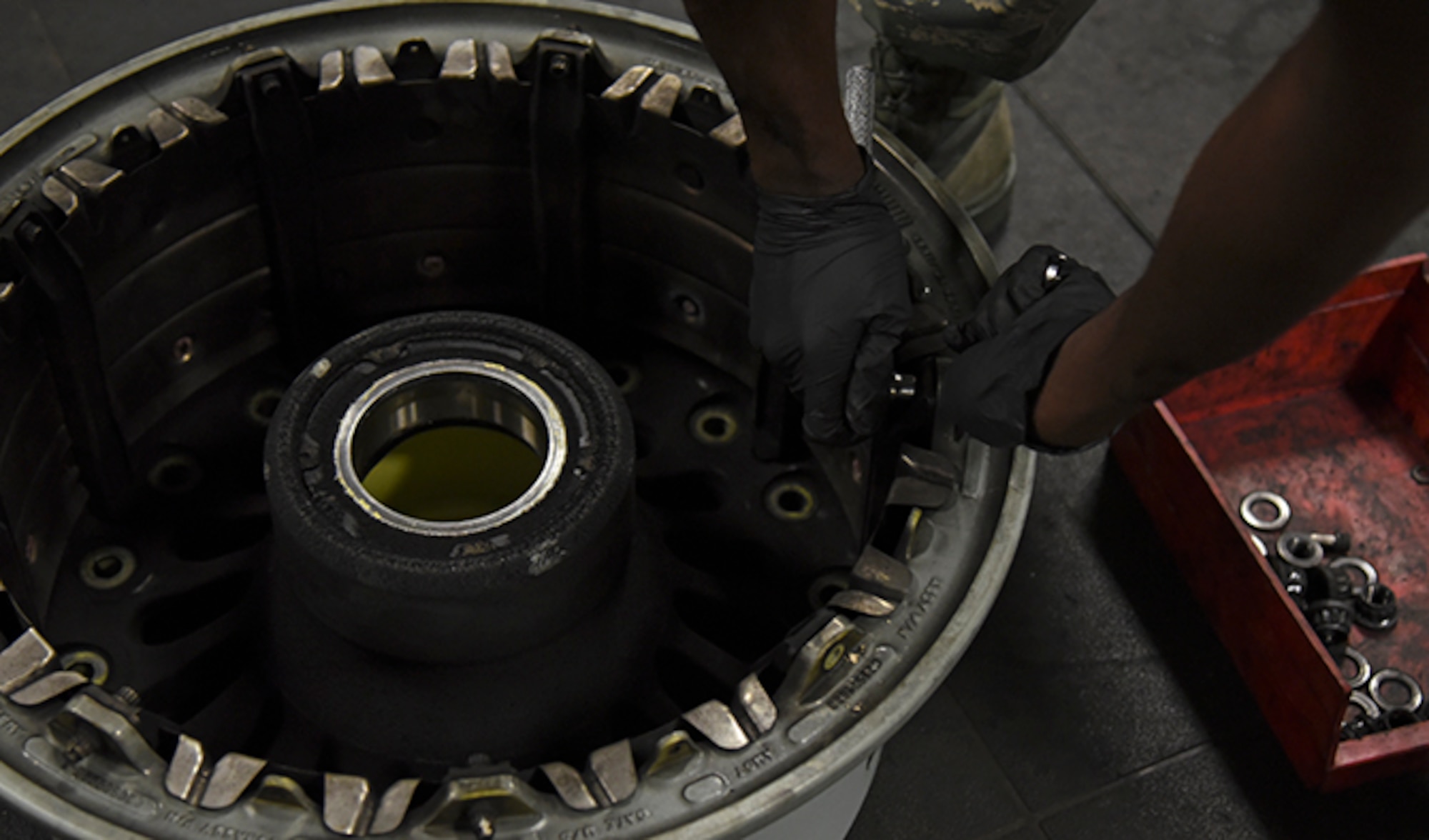 Airman 1st D’Andre Davis, 92nd Maintenance Squadron aerospace repair apprentice, finishes a tire break down at Fairchild Air Force Base July 22, 2016. The aerospace repair shop disassembles all parts of the tire to ensure there is no damage and each piece is cleaned. (U.S. Air Force photo/Airman 1st Class Mackenzie Richardson)