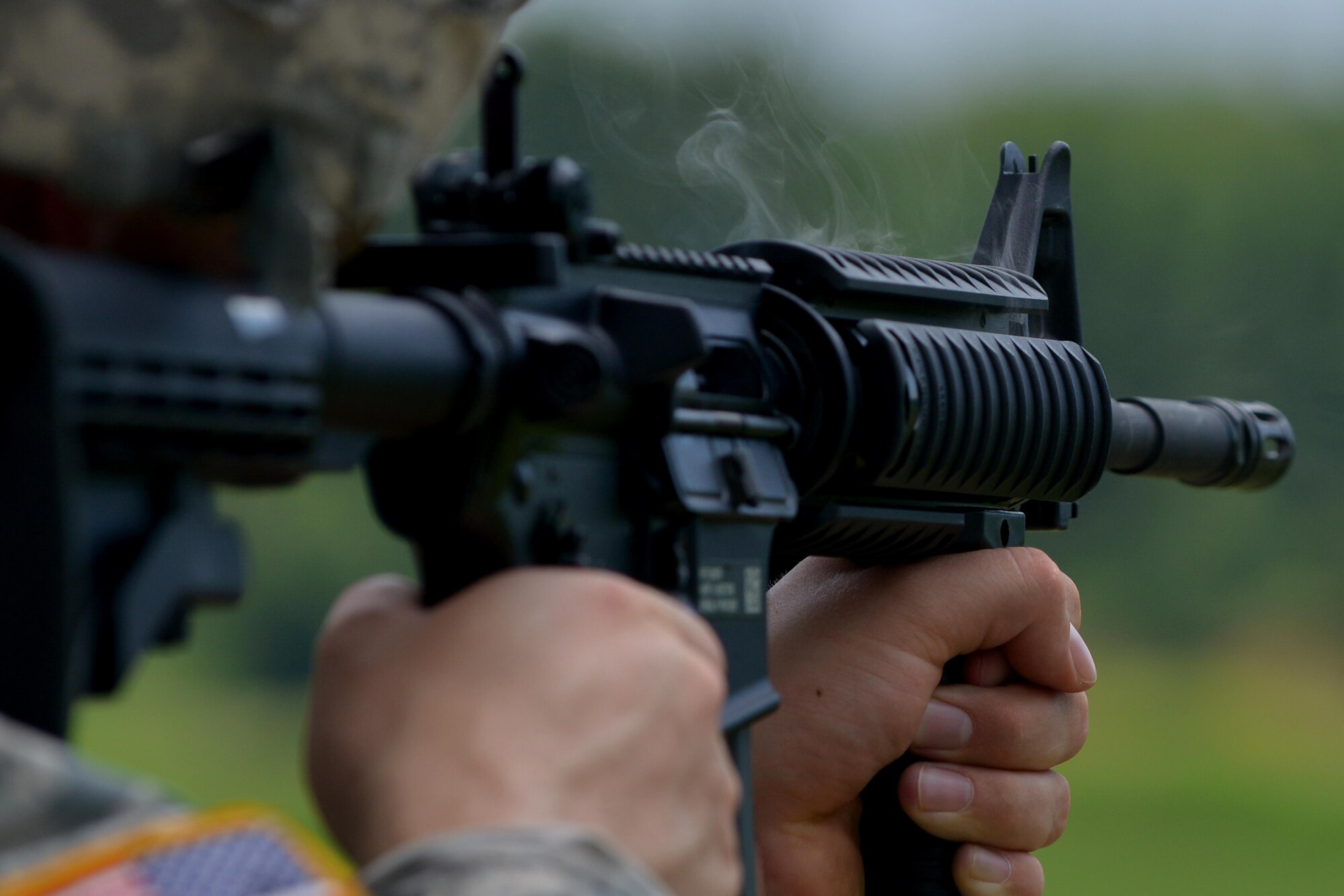 Smoke rises from an M4 rifle during a range training exercise at Fort Eustis, Va., July 20, 2016. Soldiers from the 7th Transportation Brigade (Expeditionary) Headquarters Company and 690th Rapid Port Opening Element fired about 6,500 rounds during the training exercise. (U.S. Air Force photo by Staff Sgt. Natasha Stannard)