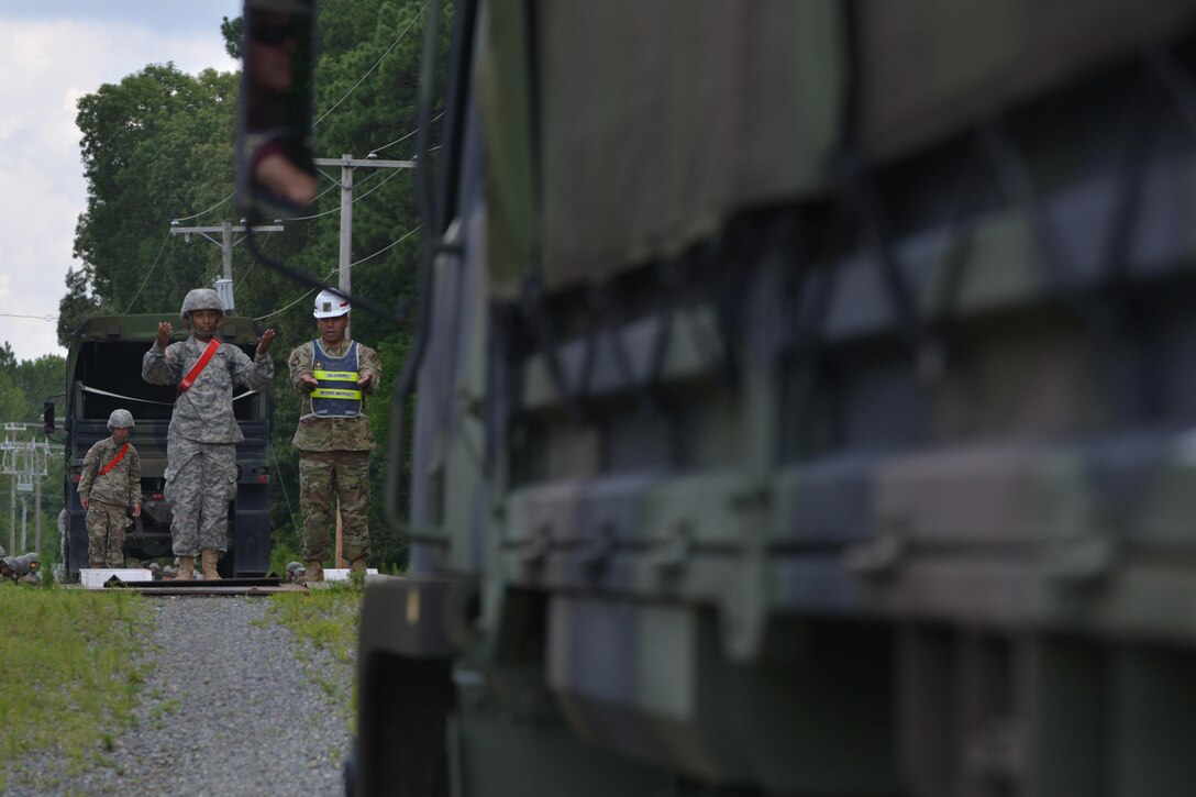 U.S. Army 7th Transportation Brigade (Expeditionary) Soldiers, load vehicles and cargo containers onto a rail car during training at Fort Eustis, Va., July 20, 2016. Technical training for a cargo specialist requires 10 weeks of Basic Combat Training and eight weeks of Advanced Individual Training with on-the-job instructions. (U.S. Air Force photo by Staff Sgt. Natasha Stannard)