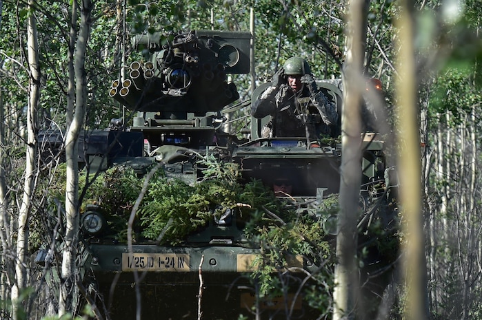 A soldier assigned to A Company, 1st Battalion, 24th Infantry Regiment, 1st Stryker Brigade Combat Team, 25th Infantry Division, U.S. Army Alaska, guides his Stryker Combat Vehicle through heavy brush from the commander’s hatch during a coordinated Opposing Forces attack in Donnelly Training Area near Ft. Greely, Alaska in the Arctic Anvil exercise, Monday, July 25, 2016. Arctic Anvil is a joint, multinational exercise which includes forces from USARAK’s 1st Stryker Brigade Combat Team, 25th Infantry Division and UATF, along with forces from the 196th Infantry Brigade’s Joint Pacific Multinational Readiness Capability, the Iowa National Guard’s 133rd Infantry Regiment and the 1st Battalion, Princess Patricia’s Canadian Light Infantry. (U.S. Air Force photo/Justin Connaher)