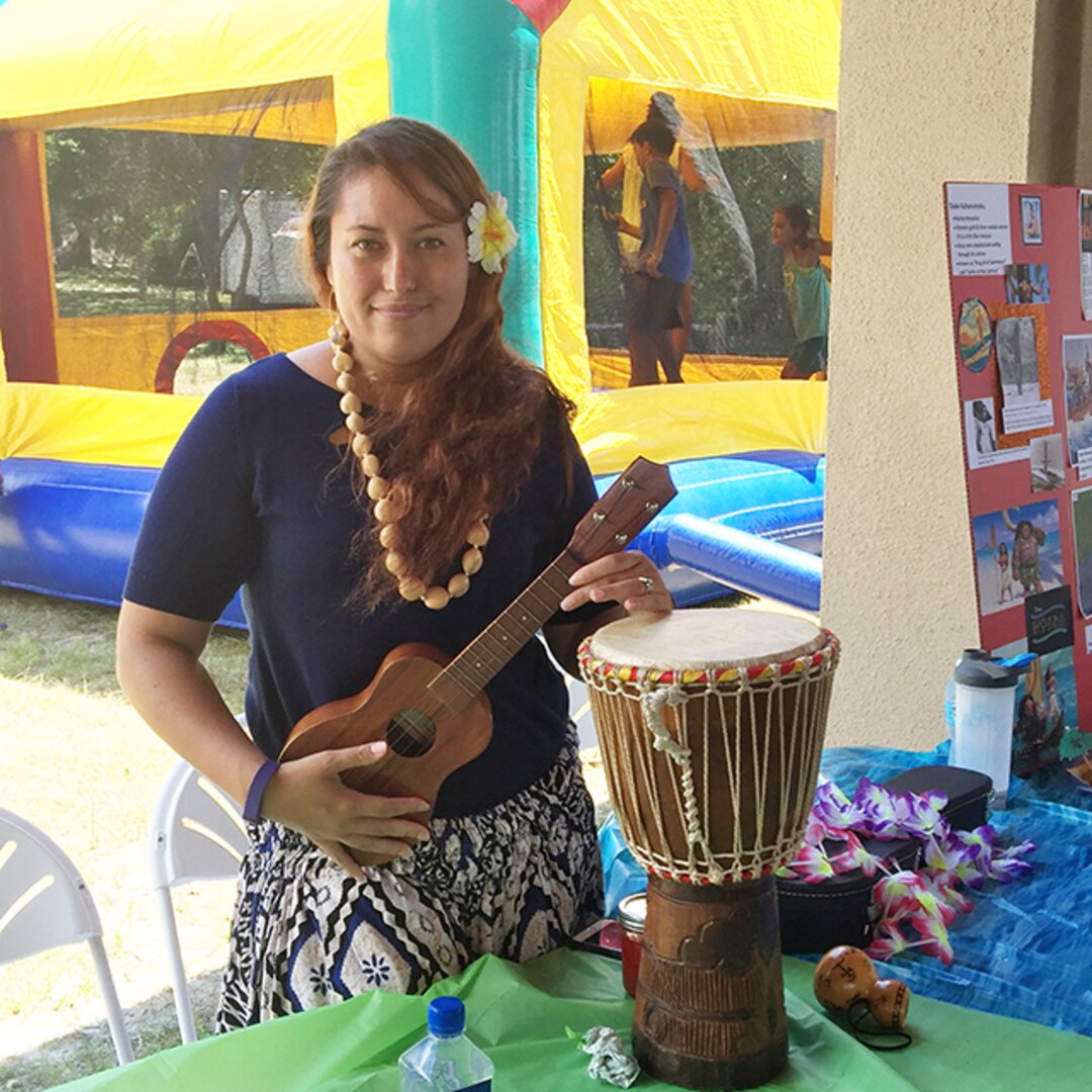 Tierra Williams, a Hawaiian native and sustainment specialist at DLA Aviation in Jacksonville, Florida played the ūkulele and spoke about the history of native Hawaiian instruments July 14, 2016 during the 8th annual Multicultural Fun Day at Naval Air Station Jacksonville. 
