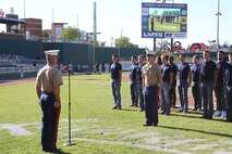 Maj. Christopher Buck, left, Recruiting Station Lansing, Mich., commanding officer, stands in preparation to administer the Oath of Enlistment to the young men and woman of Recruiting Sub Station North Lansing, led by Staff Sgt. Mark Klug, RSS North Lansing staff non commissioned officer in charge, July 22, 2016. The swear in took place before a Lansing Lugnuts baseball game during their Salute to Service night.