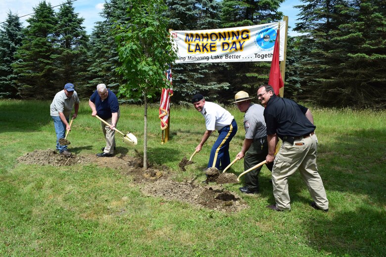 Col. Bernard Lindstrom, district commander (center) and other Mahoning Creek Lake supporters plant a tree during the lake's 75th anniversary commemoration, June 18. 