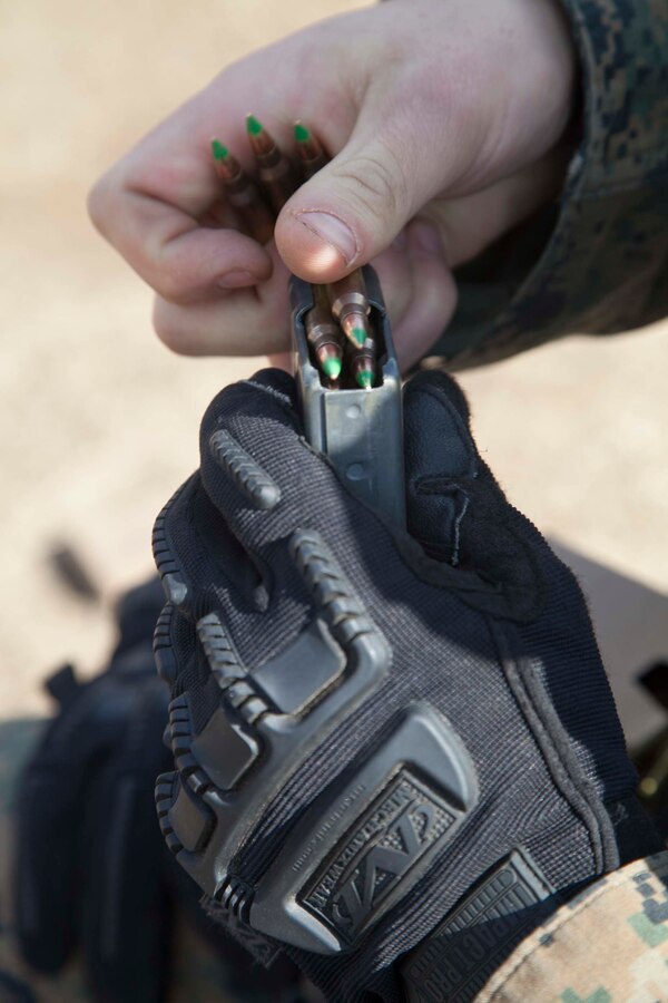 A U.S. Marine with 22nd Marine Expeditionary Unit (MEU) loads his rifle magazines during a combat marksmanship exercise at Fort Pickett, Va., Feb. 18, 2016. Marines with 22nd MEU conducted the range as a part of their predeployment training and in preparation for a future deployment. 