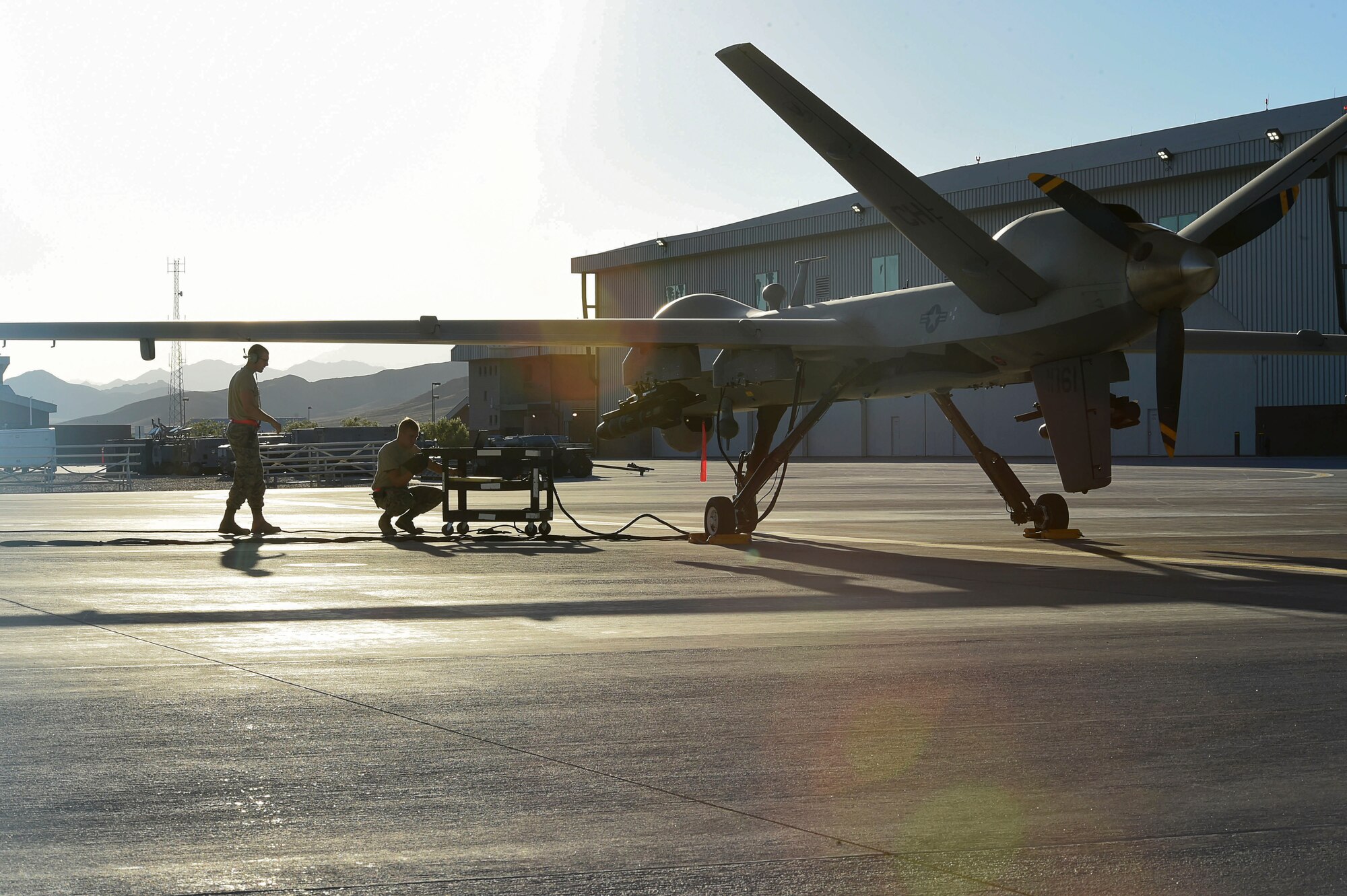 Crew chiefs assigned to the 432nd Aircraft Maintenance Squadron  prepare an  MQ-9 Reaper for takeoff in support of Red Flag 16-3 July 19, 2016, at Creech Air Force Base, Nevada. MQ-9 Reaper and MQ-1 Predator aircrews participate in the Red Flag training exercise to enhance their combat training skills.  The exercise also incorporates aircraft platforms from other U.S. military services and coalition partners in a variety of training scenarios. (U.S. Air Force photo by Airman 1st Class James Thompson/Released)