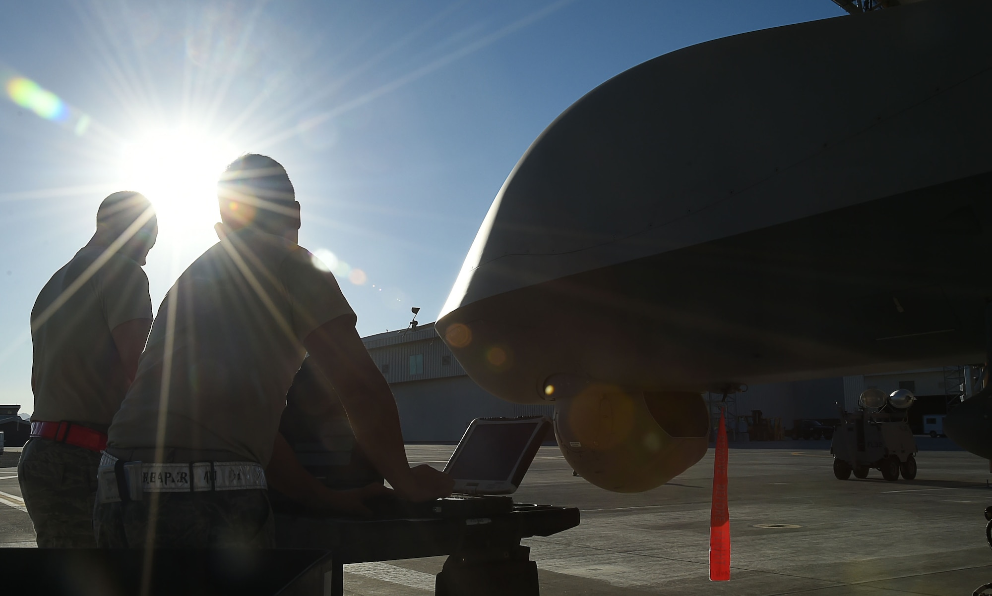 Crew chiefs assigned to the 432nd Aircraft Maintenance Squadron perform preflight checks on an MQ-9 Reaper prior to its departure in support of Red Flag 16-03 July 19, 2016, at Creech Air Force Base, Nevada.  Red Flag is a combat training exercise with emphasis on warfare tactics such as intelligence, electronic warfare, and night missions.  (U.S. Air Force photo by Airman 1st Class James Thompson/Released)