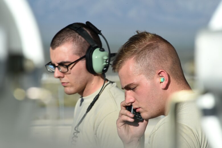 Crew chiefs assigned to the 432nd Aircraft Maintenance Squadron perform a pre-flight check for an MQ-9 Reaper July 19, 2016, at Creech Air Force Base, Nevada. Red Flag is a combat exercise held multiple times a year at Nellis Air Force Base, Nevada. (U.S. Air Force photo by Airman 1st Class James Thompson/Released)