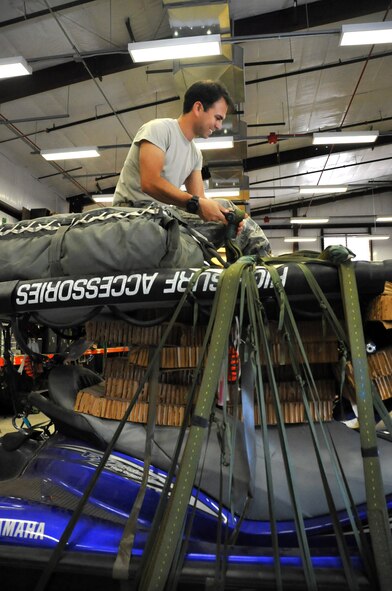 Tech. Sgt. Isaac Shapiro packages a jet ski to be air dropped at the 306th Rescue Squadron, Davis-Monthan Air Force Base, Ariz., July 14. He's an Air Force Reserve aircrew flight equipment specialist for the Guardian Angel squadron here, which is part of the 943rd Rescue Group. Shapiro transitioned to the Reserve six years ago after six years of active duty service to expand his breadth of experience and be part of the unique combat-search-and-rescue mission. (U.S. Air Force photo by Carolyn Herrick) 