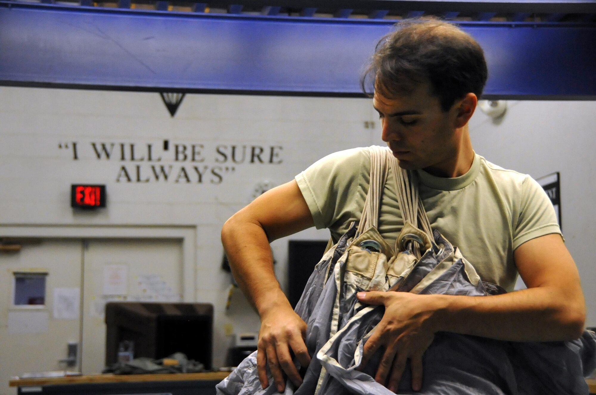 Tech. Sgt. Isaac Shapiro packs a parachute at the 306th Rescue Squadron, Davis-Monthan Air Force Base, Ariz., July 14. He's an Air Force Reserve aircrew flight equipment specialist for the Guardian Angel squadron here, which is part of the 943rd Rescue Group. Shapiro transitioned to the Reserve six years ago after six years of active duty service to expand his breadth of experience and be part of the unique combat-search-and-rescue mission. (U.S. Air Force photo by Carolyn Herrick) 