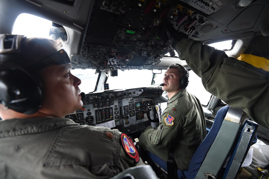 Maj. Shawn Kilbourne, left, and Maj. Matt Portno complete pre-flight checklists aboard an E-3 Sentry at Joint Base Pearl Harbor-Hickam, Hawaii, in support of Rim of the Pacific 2016 on July 23, 2016. Nearly 150 Airmen from the 513th Air Control Group and 552nd Air Control Wing are deployed to Hawaii until Aug. 4 in support of RIMPAC 2016, the world's largest international maritime exercise. (U.S. Air Force photo/2nd Lt. Caleb Wanzer)