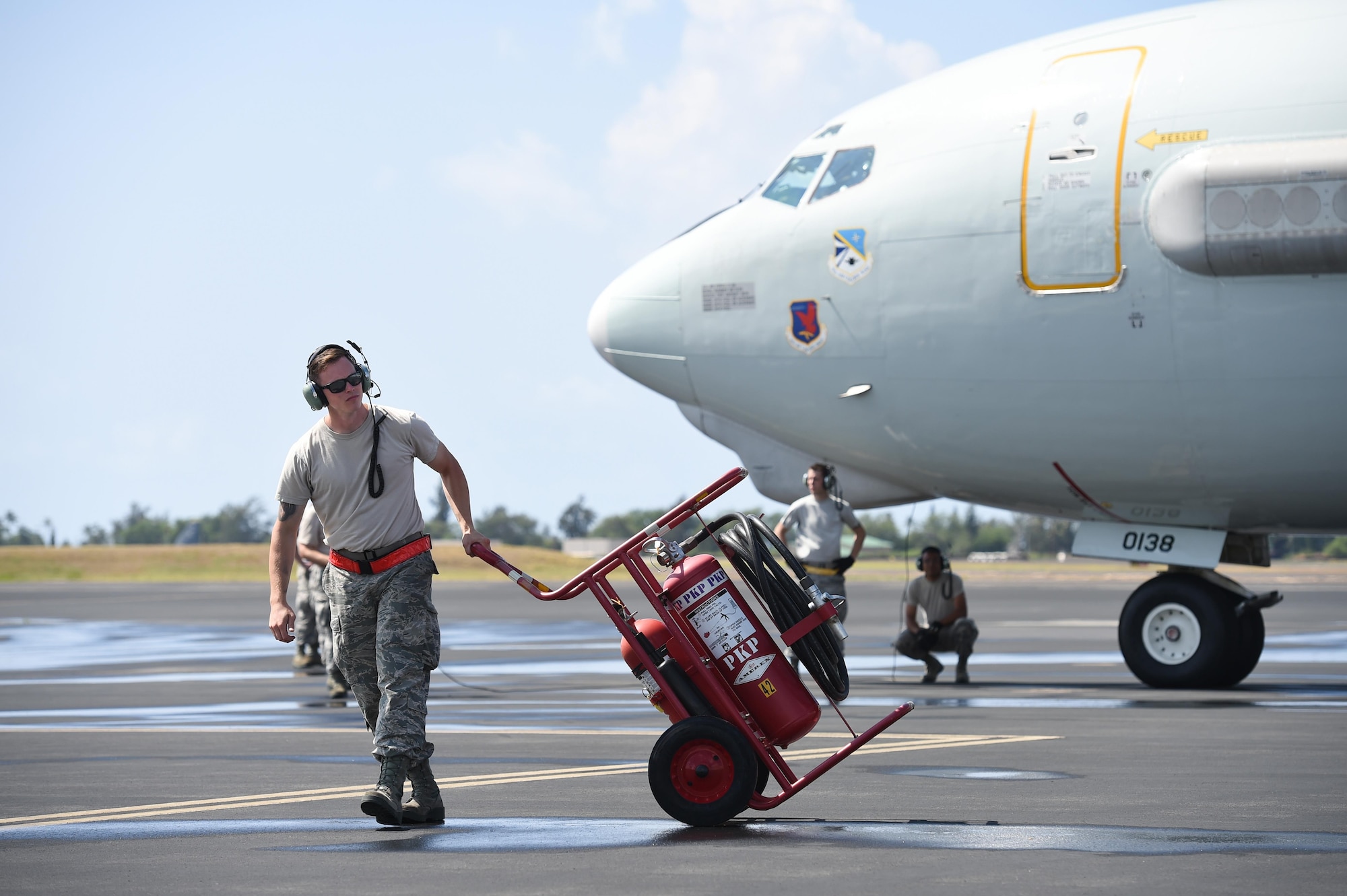 Staff Sgt. Kyle Walker, a crew chief assigned to the 513th Aircraft Maintenance Squadron, stands ready as a fire guard for an E-3 Sentry July 19, 2016 at Joint Base Pearl Harbor-Hickam, Hawaii, before a mission in support of Rim of the Pacific 2016. More than 125 Airmen from the 513th Air Control Group and 552nd Air Control Wing are deployed to Hawaii in support of the RIMPAC 2016 exercise. Twenty-six nations, more than 40 ships and submarines, more than 200 aircraft and 25,000 personnel are participating in RIMPAC from June 30 to Aug. 4, in and around the Hawaiian Islands and Southern California. The world's largest international maritime exercise, RIMPAC provides a unique training opportunity that helps participants foster and sustain the cooperative relationships that are critical to ensuring the safety of sea lanes and security on the world's oceans. RIMPAC 2016 is the 25th exercise in the series that began in 1971. (U.S. Air Force photo by 2nd Lt. Caleb Wanzer)