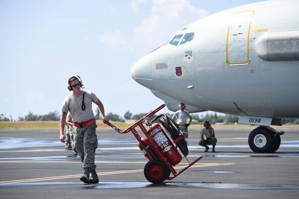 Staff Sgt. Kyle Walker, a crew chief assigned to the 513th Aircraft Maintenance Squadron, stands ready as a fire guard for an E-3 Sentry at Joint Base Pearl Harbor-Hickam, Hawaii, before a mission in support of Rim of the Pacific 2016 on July 19, 2016. RIMPAC is the world's largest international maritime exercise with 26 nations, more than 40 ships and submarines, over 200 aircraft and 25,000 personnel participating in it. (U.S. Air Force photo/2nd Lt. Caleb Wanzer)