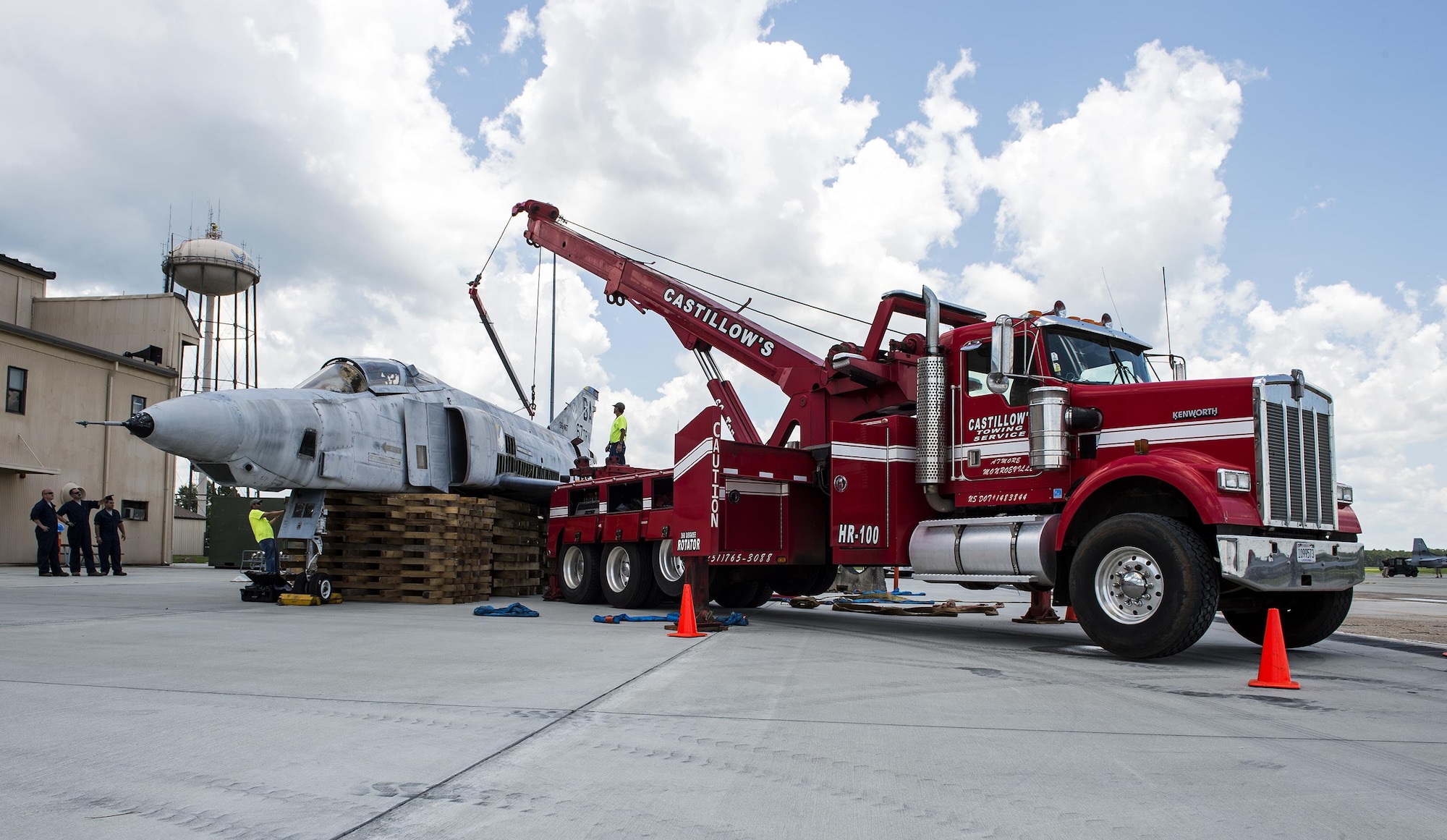 A tow truck prepares to lift an F-4 Phantom II onto a flatbed truck, July 25, 2016, at Moody Air Force Base, Ga. The F-4 has been at Moody since 2007 and will be on display at its new home at The Veteran’s Memorial Park in Excel, Ala. (U.S. Air Force photo by Airman 1st Class Janiqua P. Robinson) 