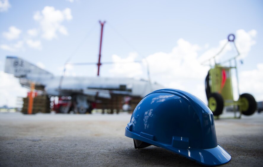 A construction helmet sits on the flightline, July 25, 2016, at Moody Air Force Base, Ga. The helmet was used as a safety precaution while Airmen lifted an F-4 Phantom II with a crane. (U.S. Air Force photo by Airman 1st Class Janiqua P. Robinson)