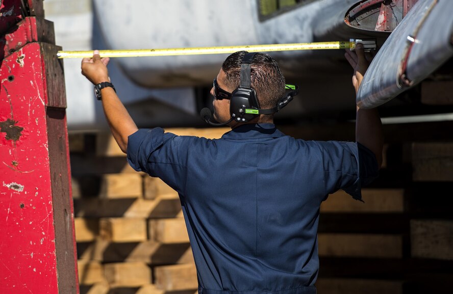 U.S. Air Force Tech. Sgt. Guillermo Rodriguez-Baez, 23d Equipment Maintenance Squadron crashed, damaged and disabled aircraft recovery team chief, measures the distance between a tow truck and an F-4 Phantom II, July 25, 2016, at Moody Air Force Base, Ga. This F-4 once belonged to the 67th Tactical Reconnaissance Wing in Japan, which was activated in 1951.  (U.S. Air Force photo by Airman 1st Class Janiqua P. Robinson)