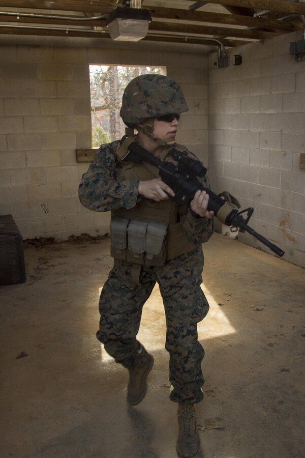 A U.S. Marine assigned to the Female Engagement Team (FET), 22nd Marine Expeditionary Unit exits a room while participating in an urban operations training exercise with the Female Engagement Team (FET) at Fort Pickett, Va., Feb. 21, 2016. The FET participated in the training in preparation for a future deployment. 