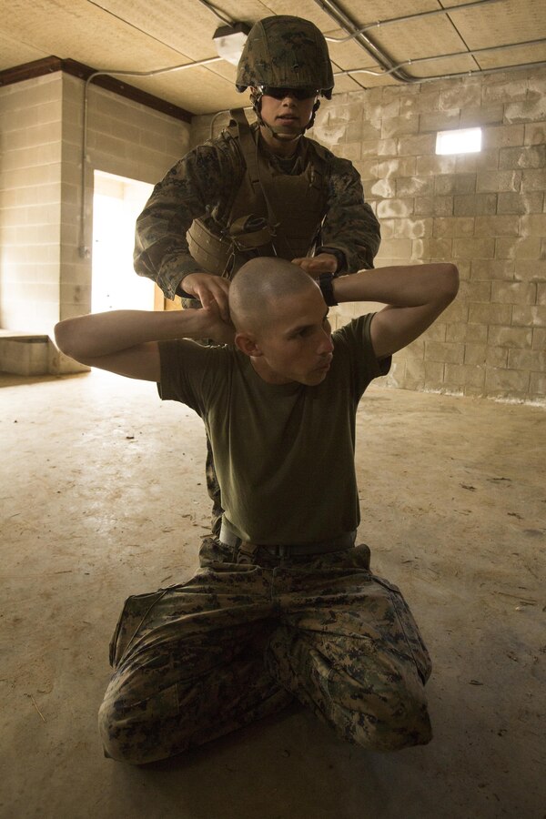 U.S. Marine Corps Lance Cpl. Meghan L. Hirzel, a gunner assigned to the Female Engagement Team (FET), 22nd Marine Expeditionary Unit, detains a roleplayer during an urban operations training exercise at Fort Pickett, Va., Feb. 21, 2016. The FET participated in the training in preparation for a future deployment. 