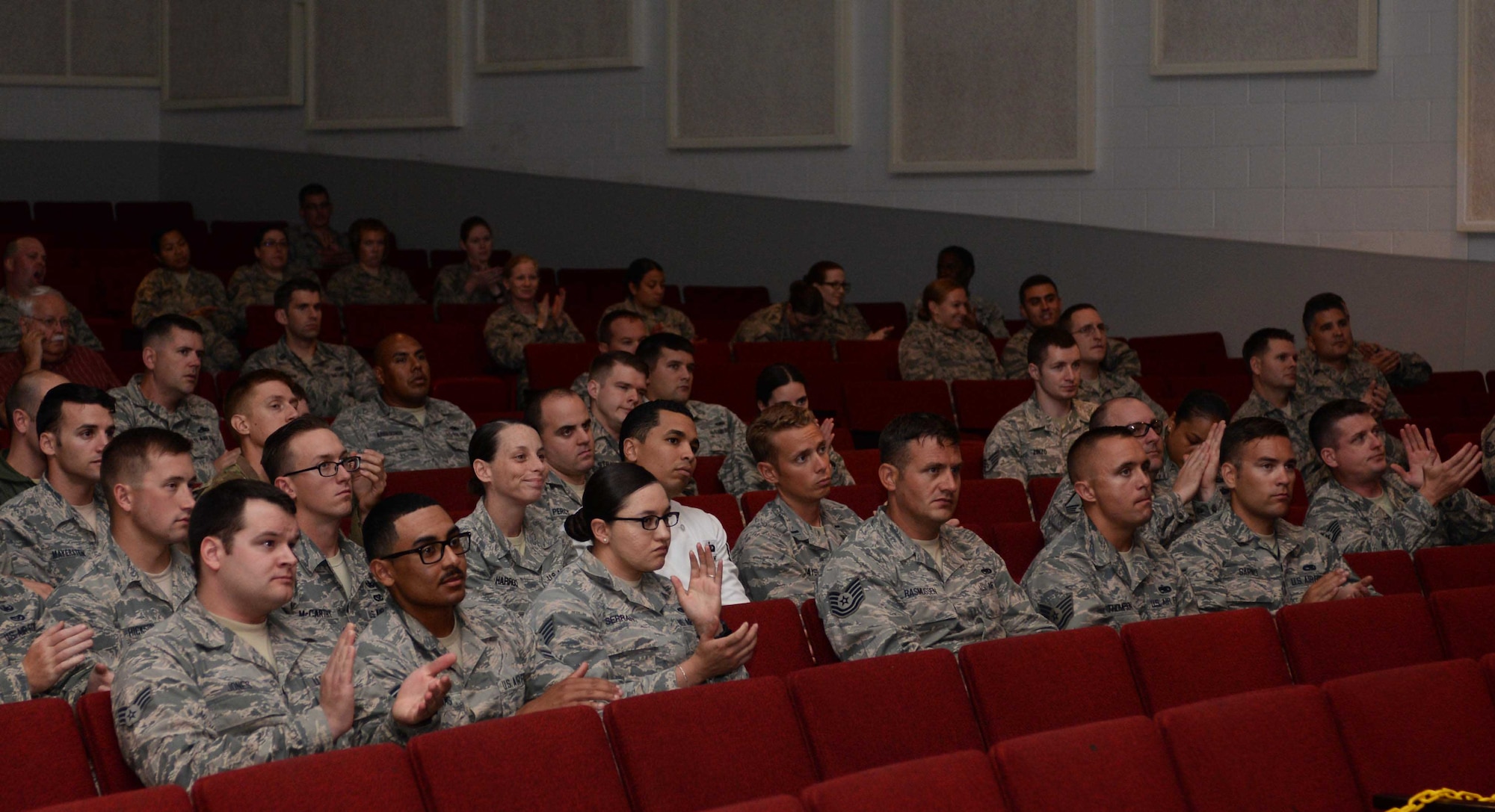 Airmen assigned to the 28th Bomb Wing applaud speakers during a Striker Speaking Series symposium at Ellsworth Air Force Base, S.D., July 21, 2016. Approximately 250 Airmen attended the panel and engaged in discussions about exercising deterrence and how their jobs contribute to that cause. (U.S. Air Force photo by Airman 1st Class Sadie Colbert)