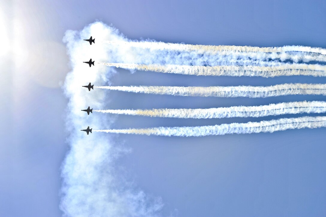 Pilots from the Blue Angels, the Navy's flight demonstration squadron, perform at an airshow in Sioux Falls, S.D., July 23. The Blue Angels are scheduled to perform 58 demonstrations at 30 locations across the United States in 2016, which is the team's 70th anniversary year. Navy photo by Petty Officer 1st Class Andrea Perez